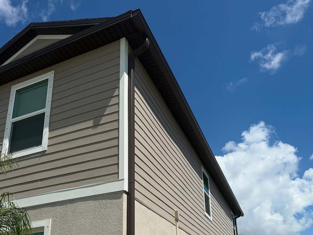 Modern suburban house with siding under clear blue sky