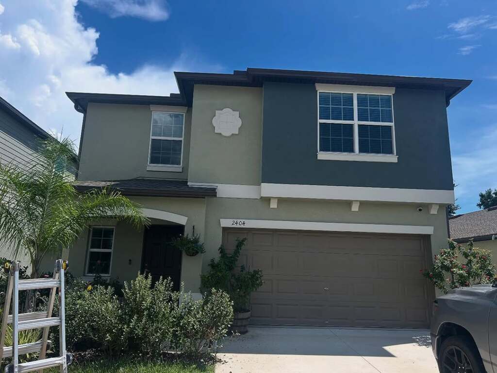 Two-story suburban house with blue siding and a garage
