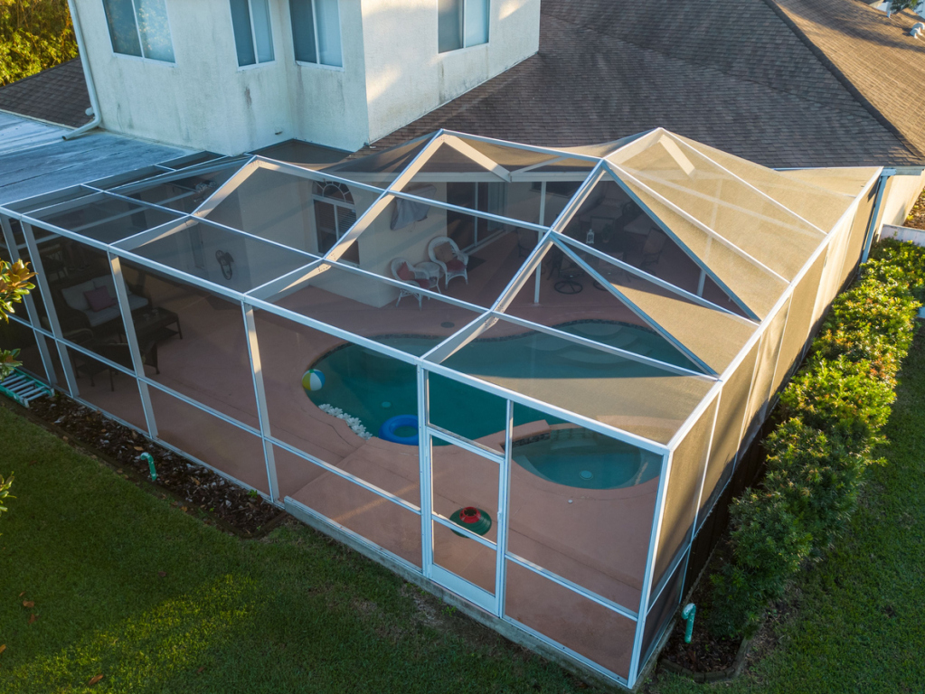 Aerial view of backyard pool with screened enclosure.