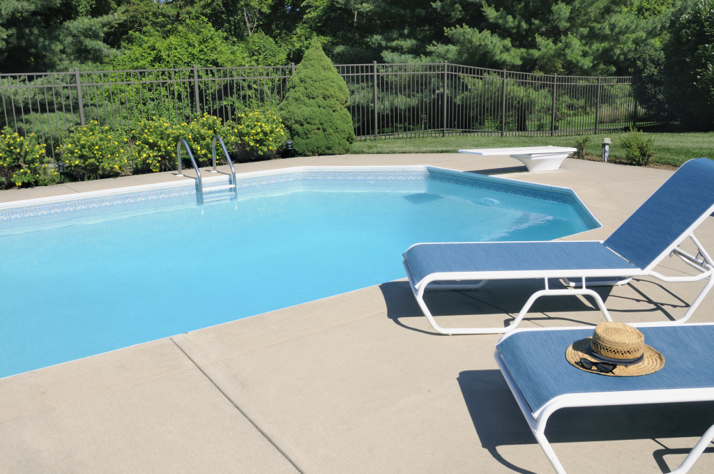 Inviting outdoor pool with lounge chairs and lush greenery
