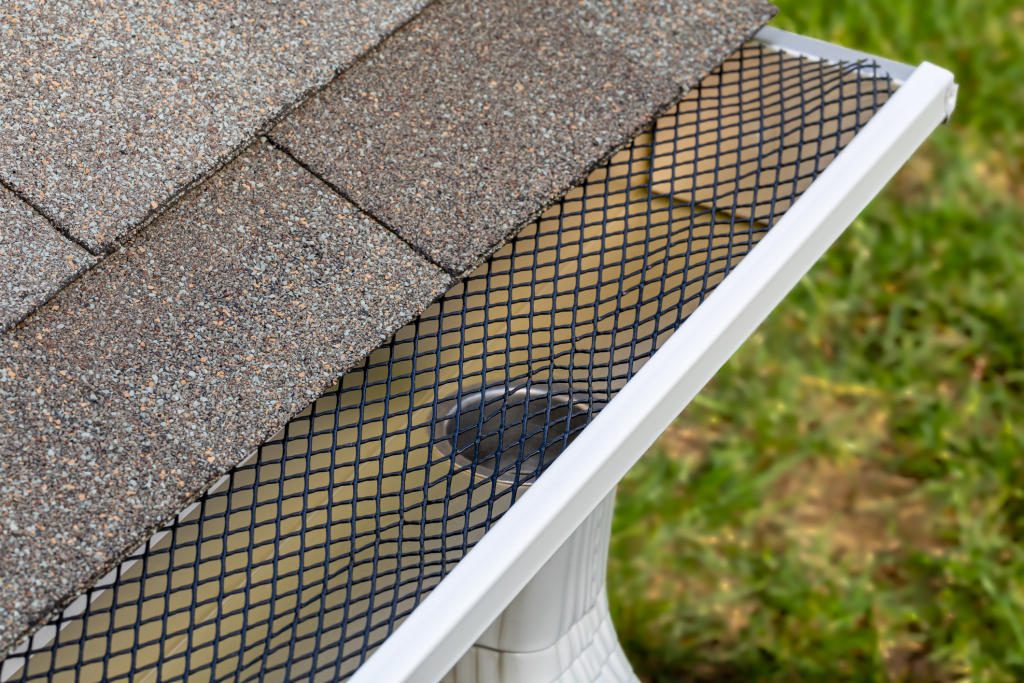 Close-up of a roof gutter with protective mesh cover