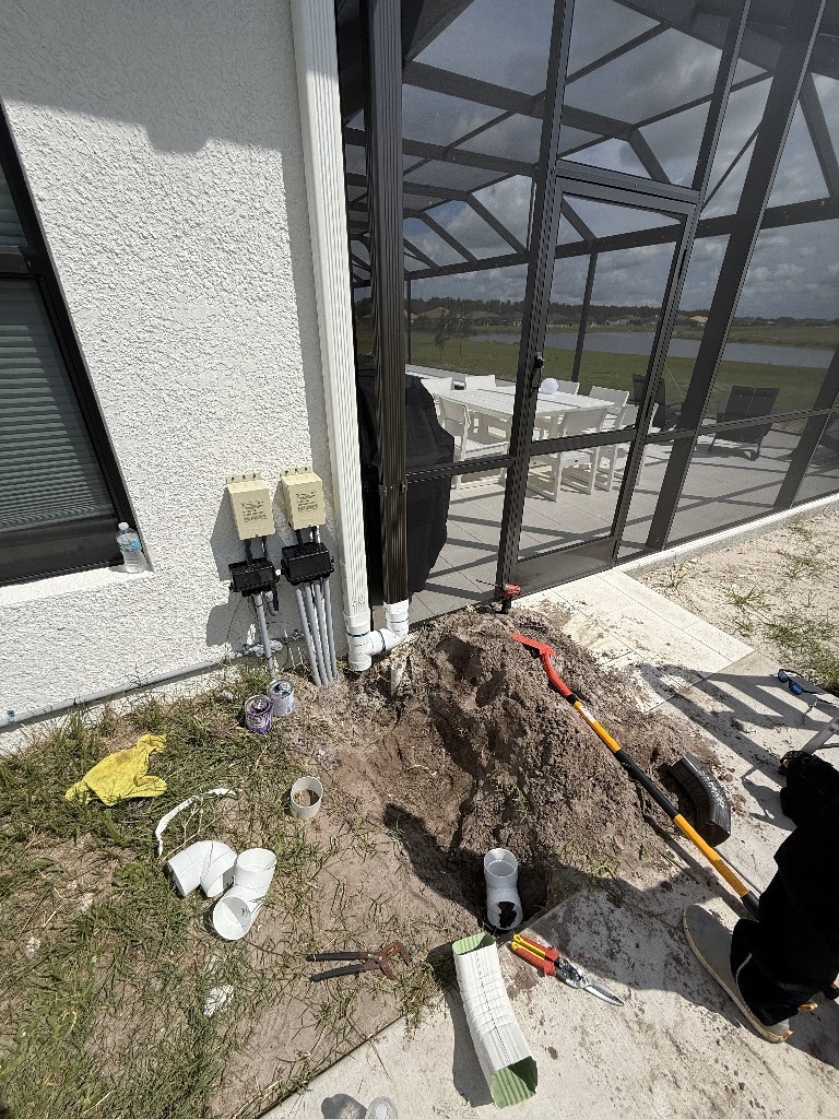Residential plumbing installation next to screened patio porch
